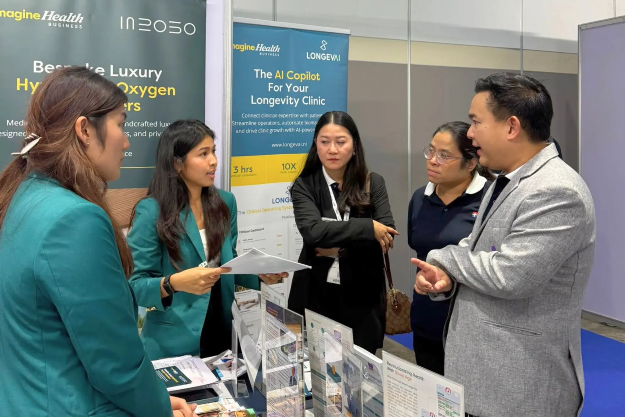 Healthcare professionals discussing longevity solutions at the ImagineHealth booth
